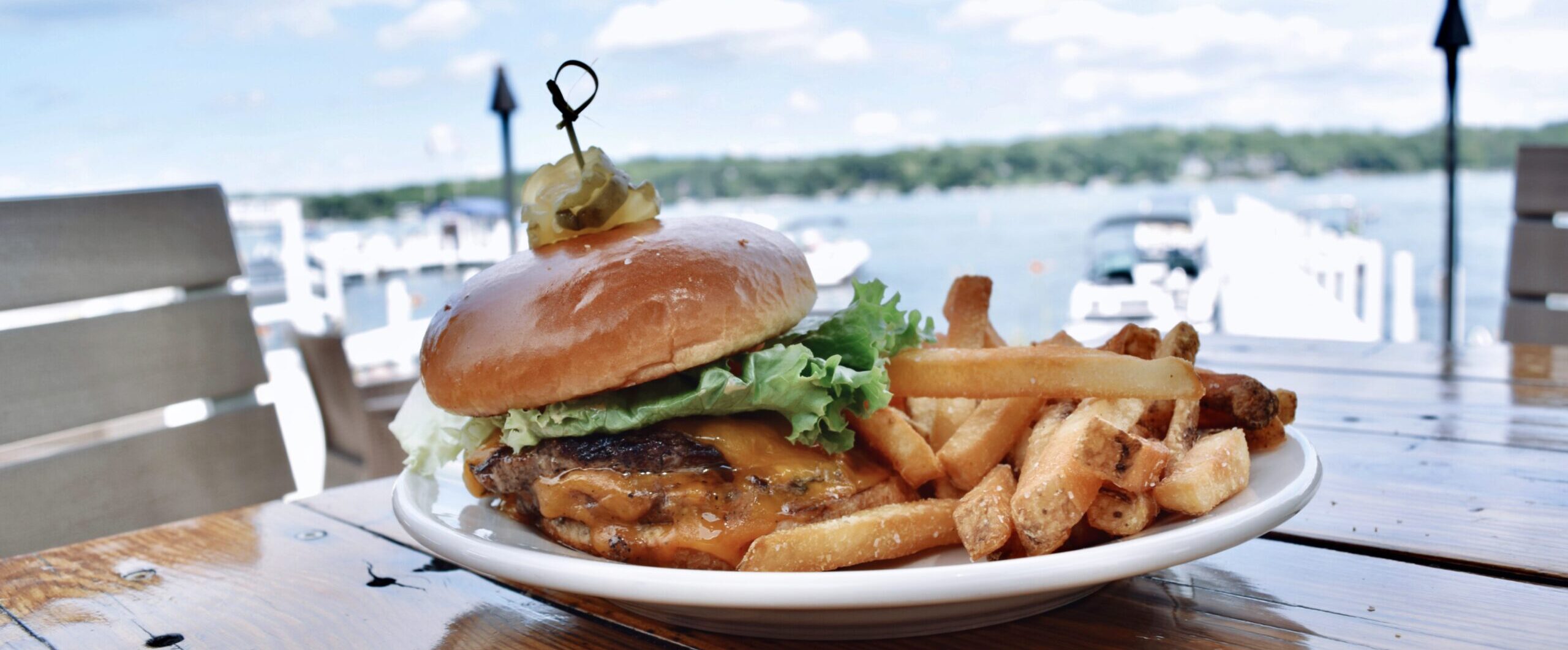 Burger on a table by the lake