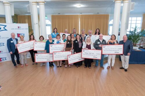 Group photo with large checks